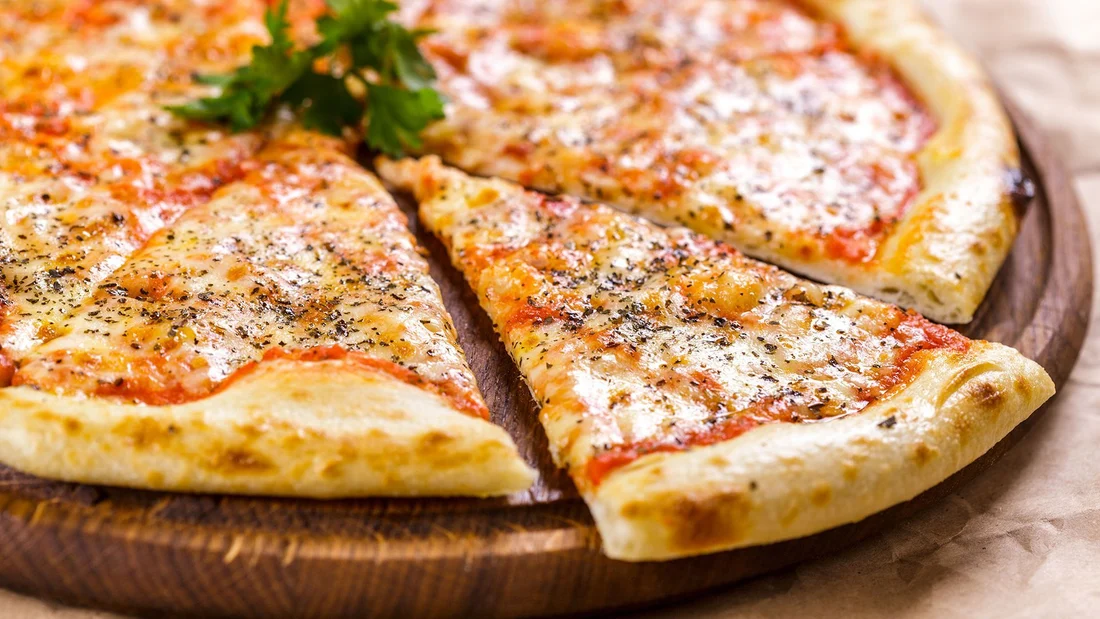 A freshly baked cheese pizza, sliced and ready to share